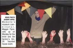  ?? NEWS PHOTO JEREMY APPEL ?? Medalta's museum coordinato­r, Maggie Flynn, sets up on Monday for the brick and tile factory's Oct. 28 haunted house event.