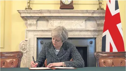  ?? Picture: Getty. ?? Prime Minister Theresa May signs the letter to trigger Article 50.