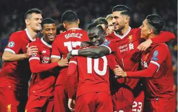  ?? AP ?? Philippe Coutinho (No 10) gets his Liverpool teammates in a celebrator­y mood after scoring his side’s fifth goal during the Champions League Group E match against Spartak Moscow.