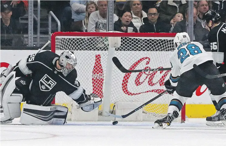  ?? — THE ASSOCIATED PRESS ?? Los Angeles Kings goalie Darcy Kuemper, left, stops a shot by San Jose Sharks right winger Timo Meier during a 4-1 Kings loss Monday in Los Angeles.