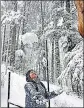  ?? ANI ?? A tourist enjoys during snowfall at Patnitop in Udhampur on Tuesday.