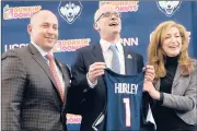  ?? STEPHEN DUNN/AP ?? Dan Hurley is flanked by UConn Athletic Director David Benedict, left, and president Susan Herbst as Hurley was introduced March 23, 2018, as men’s basketball coach.