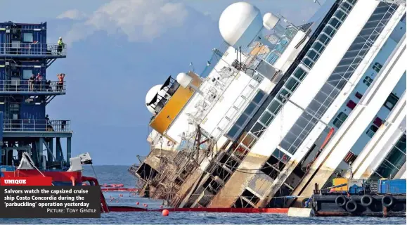  ?? PICTURE: TONY GENTILE ?? UNIQUE Salvors watch the capsized cruise ship Costa Concordia during the ‘parbucklin­g’ operation yesterday