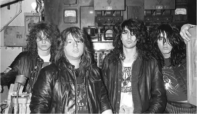  ??  ?? PIGGY (SEC OND FROM LEFT) WITH VOIVOD. THE GUITARIST PASSED AWAY IN 2005.