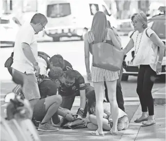  ?? ORIOL DURAN, AP ?? Police and medical officials tend to those injured after the van attack Thursday in Barcelona.