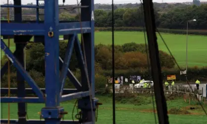  ??  ?? Anti-fracking protesters are seen on the edge of the site where shale gas developer Cuadrilla Resources have started fracking for gas. Photograph: Peter Powell/Reuters