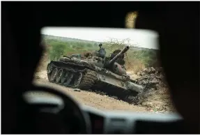  ?? (AP/Ben Curtis) ?? A destroyed tank sits by the side of the road this spring south of Humera in western Tigray in Ethiopia. A year after war began there, the findings of the only human rights investigat­ion allowed in Ethiopia’s blockaded Tigray region are to be released today.