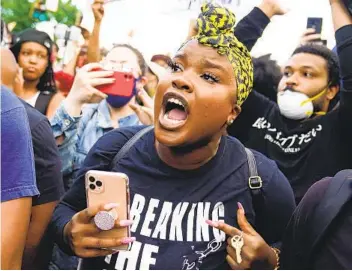 ?? ELIJAH NOUVELAGE GETTY IMAGES ?? Atlanta has been gripped by emotional protests over the death of George Floyd, who died in police custody in Minneapoli­s. Six officers have been charged after pulling two young people from a car.