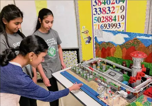 ?? Kathleen Moore / Times Union ?? Farnsworth Middle School students adjust their Future City of Lake George, which won the regional Future City competitio­n.