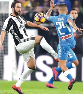  ?? Photo: AP ?? Juventus’ Gonzalo Higuain, left, and Napoli’s Lorenzo Insigne go for the ball during the first half of yesterday’s match in Turin