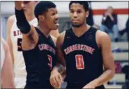  ?? DEANDRE’ PATRICK — THE NEWS-HERALD ?? Cornerston­e’s Michael Bothwell, left, and Kendall Saunders confer during the Patriots’ Division IV regional semifinal win March 13 at Canton Fieldhouse.