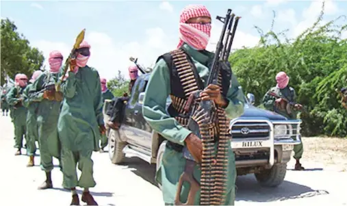  ??  ?? Al-Shabab militants display their weapons in Somalia. (AFP)