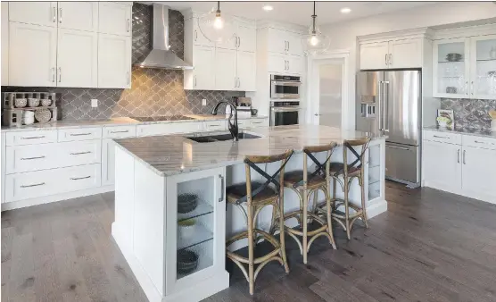  ?? PHOTOS: MORRISON HOMES ?? The kitchen in the Wakefield show home by Morrison Homes in Legacy features a large island with a double sink and extra storage space.