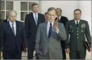  ?? RON EDMONDS — THE ASSOCIATED PRESS FILE ?? In this file photo, President George H.W. Bush talks to reporters in the Rose Garden of the White House after meeting with top military advisors to discuss the Persian Gulf War. From left are, Defense Secretary Dick Cheney, Vice President Dan Quayle, White House Chief of Staff John Sununu, the president, Secretary of State James A. Baker III, and Joint Chiefs Chairman Gen. Colin Powell. Bush died at the age of 94 on Friday about eight months after the death of his wife, Barbara Bush.