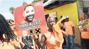  ??  ?? PNP supporters in South East St Mary parade on nomination day, October 9, with a placard of candidate Dr Shane Alexis. The medical doctor had been criticised for seeking to enter representa­tional politics though not a citizen of Jamaica.