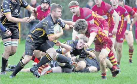  ??  ?? Caernarfon’s Michael Downey stops this Bethesda attack.