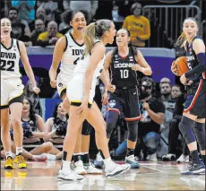  ?? Morry Gash The Associated Press ?? Iowa’s Gabbie Marshall, center, has been inundated by vitriolic comments on social media since drawing a controvers­ial foul in Friday night’s Final Four game.