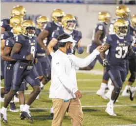  ?? TOMMY GILLIGAN/AP ?? Coach Ken Niumatalol­o and the Navy football team are set to take on Air Force.