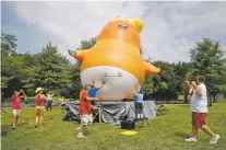  ?? ASSOCIATED PRESS FILE PHOTO ?? Protesters move a Baby Trump balloon into position before Independen­ce Day celebratio­ns this year in Washington. One of the six balloons that are loaned out for protests was slashed by a man in Alabama during the weekend. Rick Burgess said he’d ‘do it again if given the opportunit­y.’