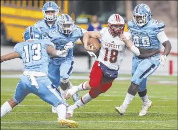  ??  ?? Liberty junior quarterbac­k Daniel Britt cuts up field past Centennial defenders Donte Washington (3) and Keaun Jackson (99) and sidesteps the Bulldogs’ Ronaven Mokiao (13) in the second quarter of the Class 4A state football title game.