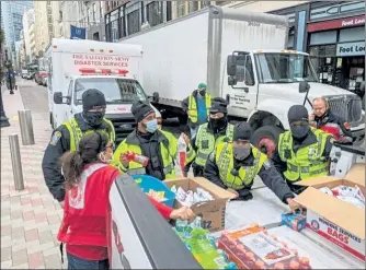  ?? COURTESY SALVATION ARMY OF FITCHBURG ?? Fitchburg EDS member Eileen Ramsden hands out food and beverages to police officers in Boston on Jan. 20.