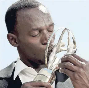  ??  ?? Usain Bolt kissing the Laureus Award after one of his three previous triumphs.