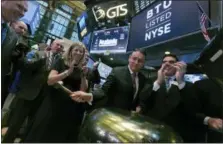 ?? RICHARD DREW — THE ASSOCIATED PRESS ?? Peabody Energy Corp. President & CEO Glenn Kellow, second from right, joined by company CFO Amy Schwetz, rings a ceremonial bell as his company’s stock begins trading on the floor of the New York Stock Exchange, Tuesday.