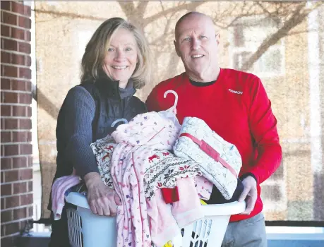  ?? DAN JANISSE ?? Carrie Lee and her husband Martin Denonville, organizers of Lola's Pajama Fairy Project, deliver cosy comfort during the holiday season.