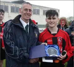  ??  ?? Mick Larkin of the Wexford League presents the man of the match award to Cillian Gilligan of Gorey Rangers.