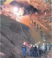  ?? coach. ROYAL THAI ARMY ?? RIGHT Standing in a long line on a flooded path in Tham Luang cave has become routine for military personnel assigned to help clear obstacles to the mission to rescue 12 boys and their football