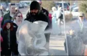  ?? JONATHAN TRESSLER – THE NEWS-HERALD ?? Ice sculptor Jeff Meyers from Elegant Ice sprays shaved ice as he works to create the likeness of an eagle out of a solid block of ice.