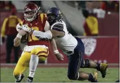  ?? ALEX GALLARDO — THE ASSOCIATED PRESS FILE ?? Southern California quarterbac­k JT Daniels, left, is sacked by California defensive end Luc Bequette during the first half of an NCAA college football game in Los Angeles.