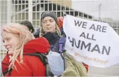  ?? — AP ?? BERLIN: Demonstrat­ors wait for the launch of the Civil March for Aleppo at the air field of the former Tempelhof airport yesterday.