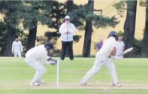  ??  ?? Eye on the ball Wicketkeep­er Peter Drummond keeps the batsman on his toes