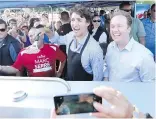  ?? NATHAN DENETTE, THE CANADIAN PRESS ?? Prime Minister Justin Trudeau flips a burger Monday at the federal Liberal cabinet retreat in Sudbury, Ont.