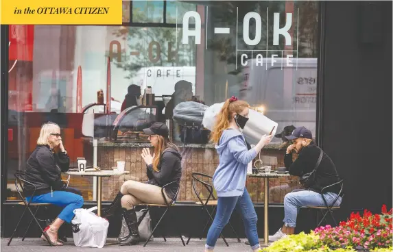  ?? PETER J THOMPSON / NATIONAL POST ?? Masked pedestrian­s walk past a coffee shop on Toronto's Bloor Street on Thursday, as Ontario tightened the number of people who can congregate in one place.