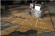  ?? AP PHOTO/KAREN PULFER FOCHT ?? Candles spell out the name of Tyre Nichols during a candleligh­t vigil for him Sunday in Memphis on the anniversar­y of his beating.