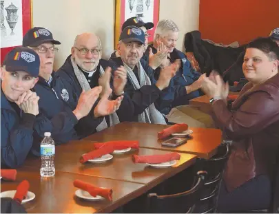  ?? STAFF PHOTOS BY CHRIS CHRISTO ?? READY TO MARCH: Members of the gay veterans group OutVets applaud, above, as Director Bryan Bishop speaks during yesterday’s press conference. Below, Bishop, left, chats with City Council candidate Ed Flynn and South Boston state Rep. Nick Collins.