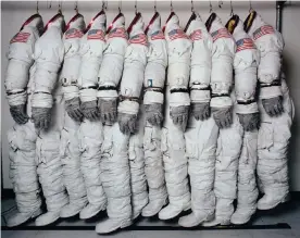  ??  ?? Apollo Spacefligh­t Training Suits, 1978, by Hiro. His picture of a rack of astronaut suits, cramped tight as if already in a capsule, is an enduring Nasa image. Photograph: HIRO/© Hiro