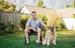  ?? GRANT HINDSLEY / THE NEW YORK TIMES ?? Matt Kaeberlein, a co-director of the Dog Aging Project, with Dobby, his 12-year-old German shepherd, in their Seattle backyard in 2022. The National Institute on Aging may let funding lapse for a yearslong study of nearly 50,000 pet dogs, which could also offer insights into human health.