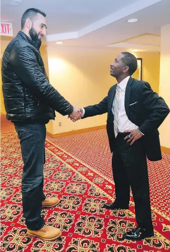  ?? DAN JANISSE/WINDSOR STAR ?? Express CEO Dartis Willis, right, greets Herman grad Ljubisa Vrcelj at a team orientatio­n meeting Wednesday at the Holiday Inn.