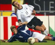  ?? CHRISTOF STACHE — THE ASSOCIATED PRESS FILE ?? In this file photo, USA’s Gregg Berhalter, bottom, tackles Germany’s Miroslav Klose during their 2002 World Cup quarterfin­als soccer match at the Munsu Football Stadium in Ulsan, South Korea.