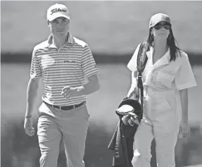  ?? MICHAEL MADRID/USA TODAY SPORTS ?? Justin Thomas, with girlfriend Jillian Wisniewski in the Par 3 Contest, plans to be more aggressive in his golf game in the Masters.