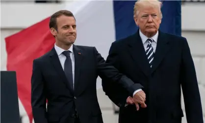  ?? Photograph: Andrew Harnik/AP ?? President Donald Trump and French president Emmanuel Macron hold hands on the South Lawn of the White House.