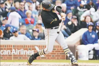  ?? Jeff Haynes/Associated Press ?? Francisco Cervelli doubles in two runs in the sixth Friday against Chicago at Wrigley Field.