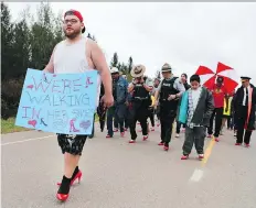  ?? MICHELLE BERG ?? Tyler Walker was among a group of men and youths who took part in the annual Walk for Missing and Murdered Indigenous Women at Ahtahkakoo­p Cree Nation Tuesday.