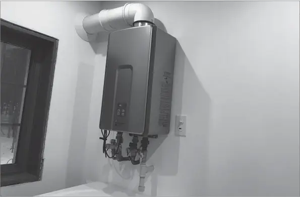  ?? ROBERT MAXWELL ?? Gas-fired tankless water heaters like this one can heat water regardless of how cold the supply is. Proper sizing of the unit is key to reliable performanc­e.