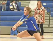  ?? Scott Herpst ?? Ringgold senior Makenna Mercer makes a dig as head coach Ashley Boren watches from the sideline. The Lady Tigers put up a fight against Calhoun in a loss, but scored a win over Christian Heritage in a home tri-match last week.
