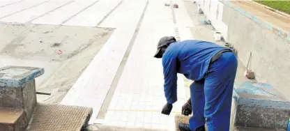  ?? ?? A worker measuring for new diving boards