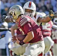  ?? AL DIAZ adiaz@miamiheral­d.com ?? Hurricanes defensive lineman Gregory Rousseau sacks Florida State quarterbac­k Alex Hornibrook on Nov. 2, 2019.